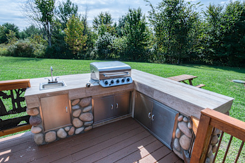 An outdoor kitchen with barbecue