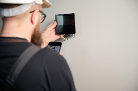 A professional is fitting a new automation system.