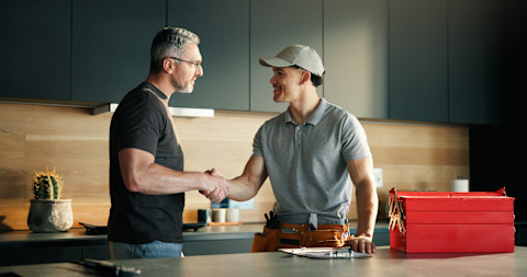 A man is shaking hands with a general contractor.