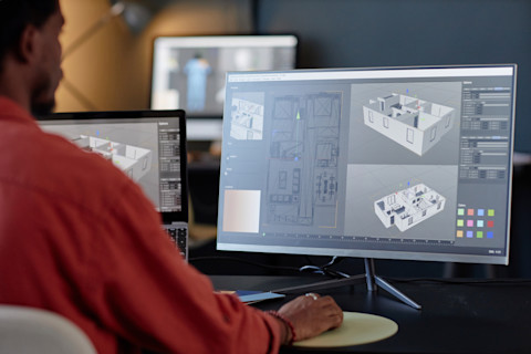 An interior designer is looking at a 3D interior design.