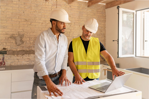 Two architects are working on some plans for a new build